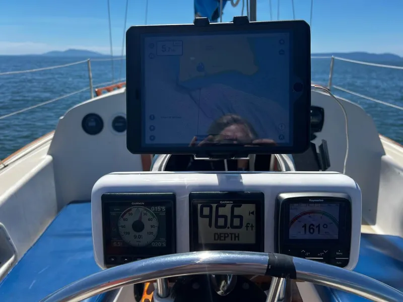Slide: The Image of Cockpit of 1982 O'Day 28 sailboat with navigation instruments and tablet display. - 17