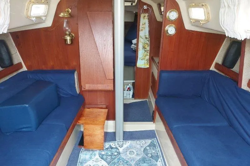 Slide: The Image of Interior of 1982 O'Day 28 sailboat with blue seating and wooden accents. - 25