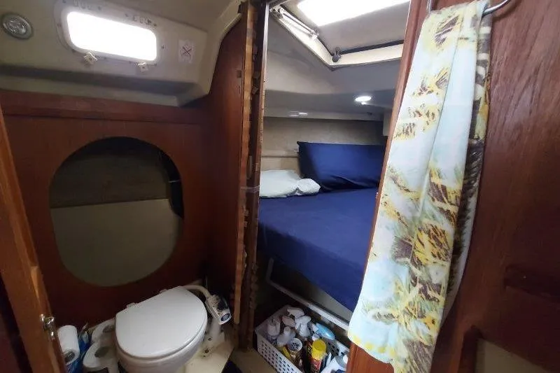 Slide: The Image of 1982 O'Day 28 sailboat interior with bed, bathroom, and storage. - 28