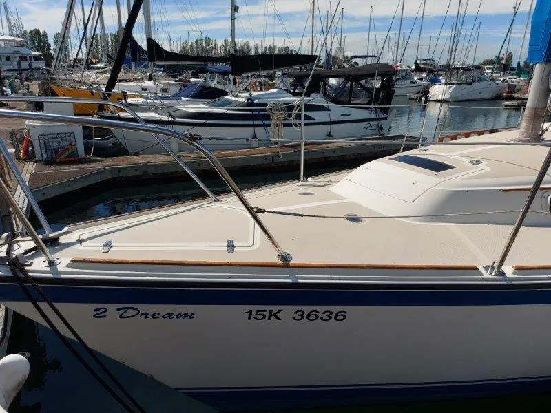 Slide: The Image of 1982 O'Day 28 sailboat named "2 Dream" docked in a marina. - 3