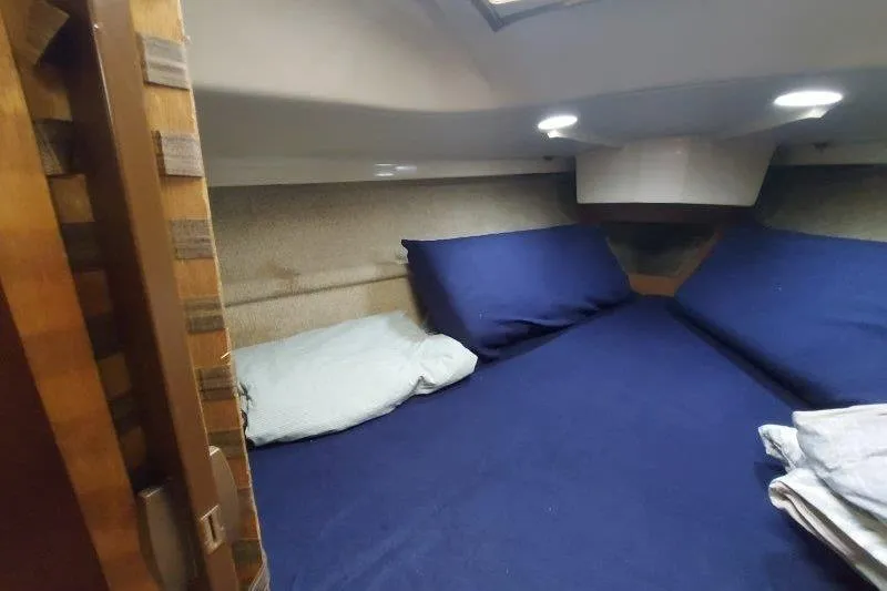 Slide: The Image of Cozy cabin interior of 1982 O'Day 28 sailboat with blue bedding. - 32