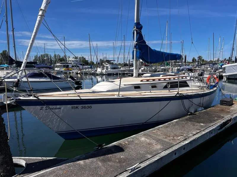 Slide: The Image of 1982 O'Day 28 sailboat docked in marina under clear blue sky. - 4