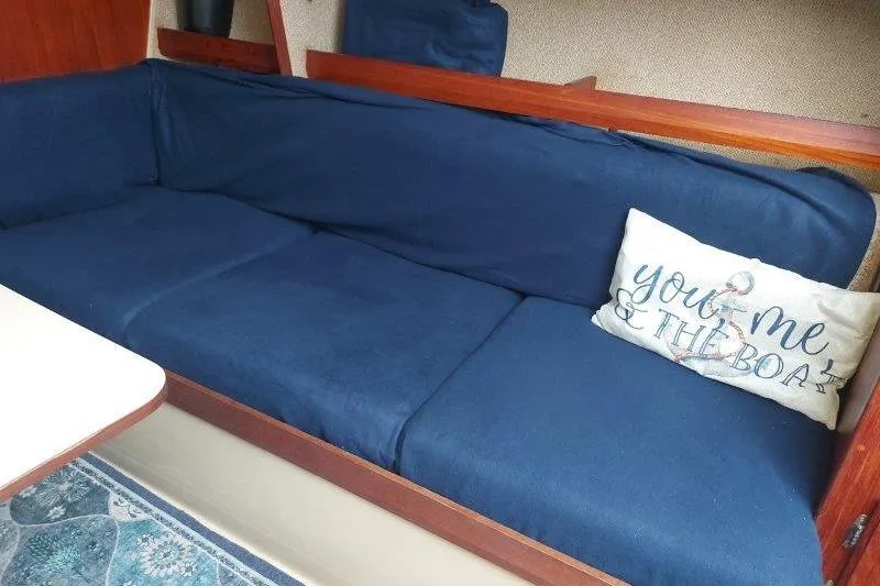 Slide: The Image of Interior of 1982 O'Day 28 sailboat with blue cushions and decorative pillow. - 41