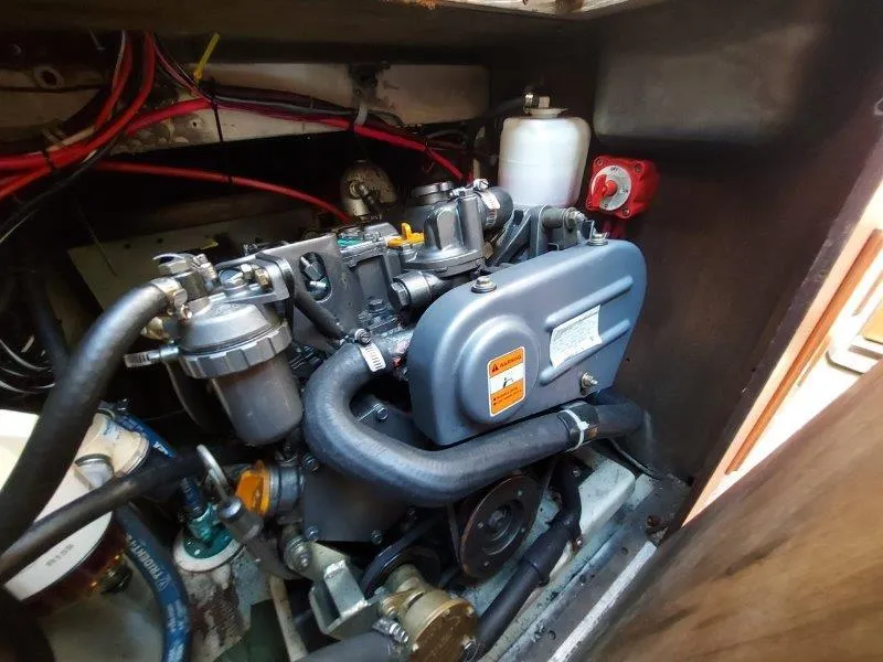 Slide: The Image of Engine compartment of a 1982 O'Day 28 sailboat, showcasing detailed mechanical components. - 43