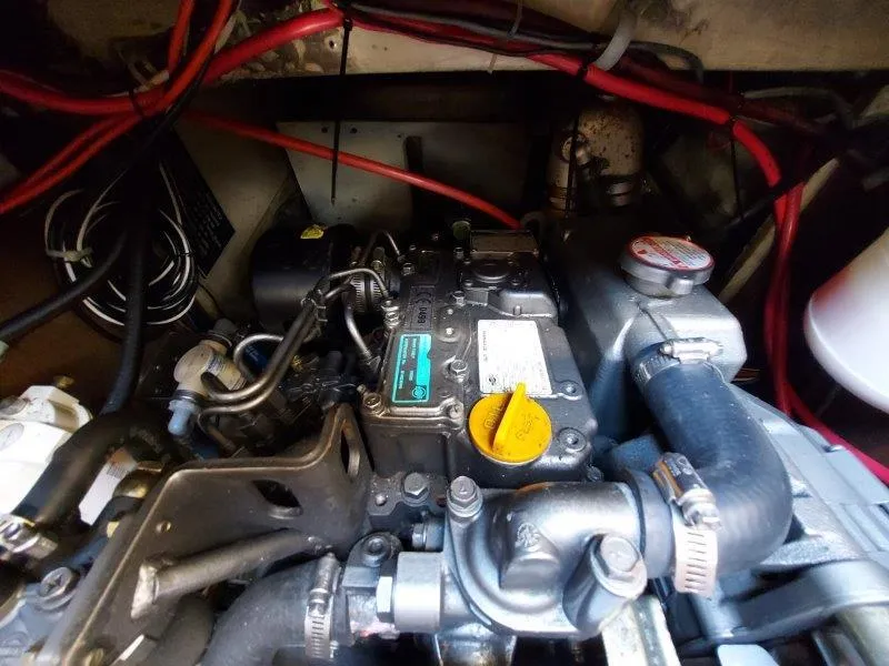 Slide: The Image of Engine compartment of a 1982 O'Day 28 sailboat with visible wiring and components. - 45