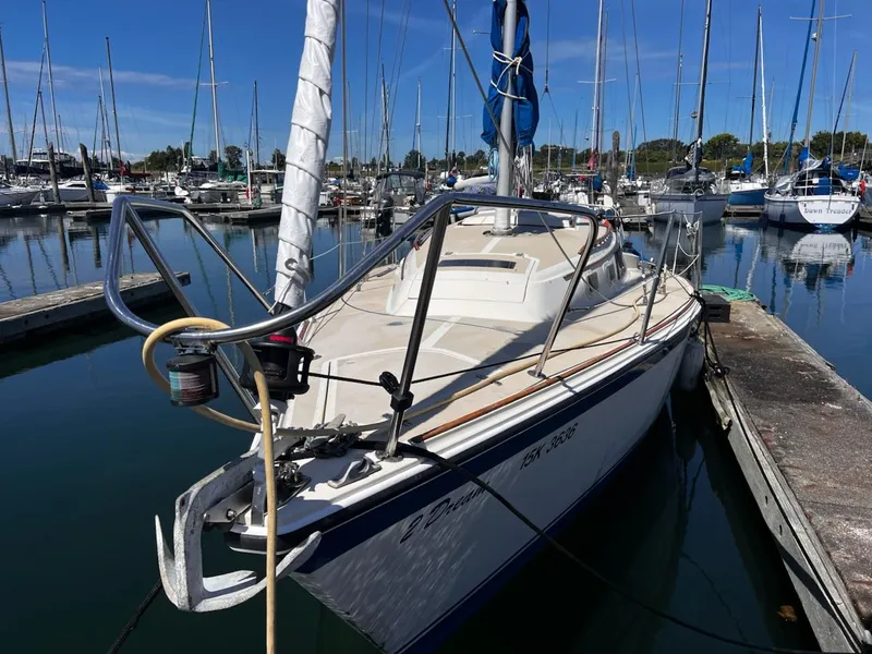 Slide: The Image of 1982 O'Day 28 sailboat docked in a marina, surrounded by other boats. - 5