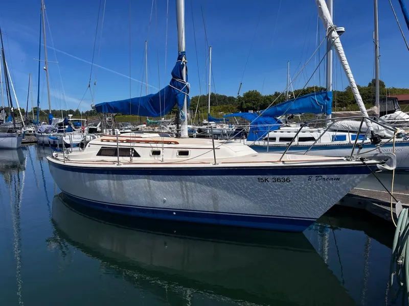 Slide: The Image of 1982 O'Day 28 sailboat docked in a marina under clear blue skies. - 6