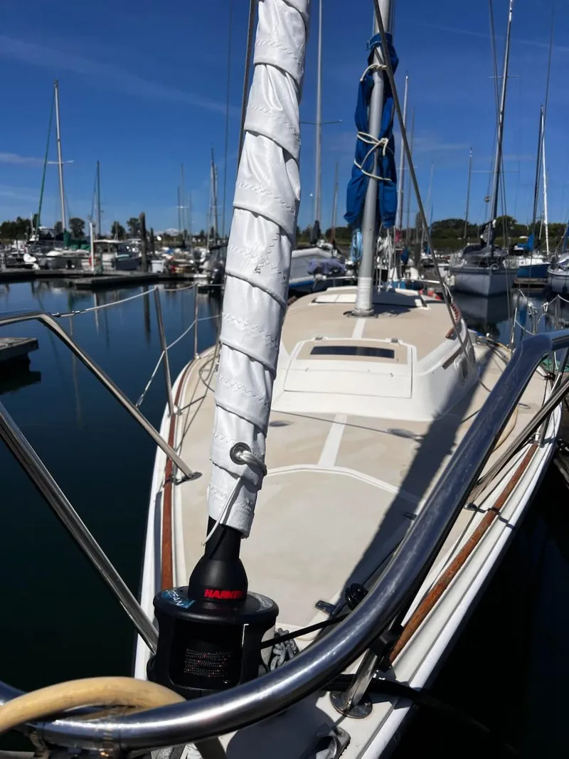 Slide: The Image of 1982 O'Day 28 sailboat docked in a marina under clear blue skies. - 7