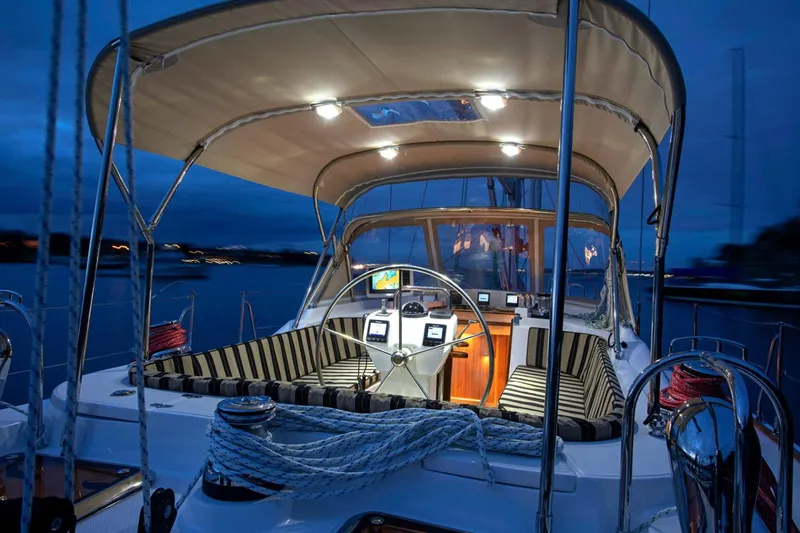 Slide: The Image of Manufacturer Provided Image: Luxurious 2025 Hylas H48 yacht cockpit at dusk, featuring elegant seating and modern navigation equipment. - 5