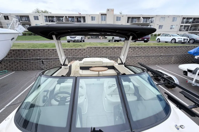 Slide: The Image of 2026 Chris-Craft Sportster 25 boat with sleek design, parked in a marina. - 22