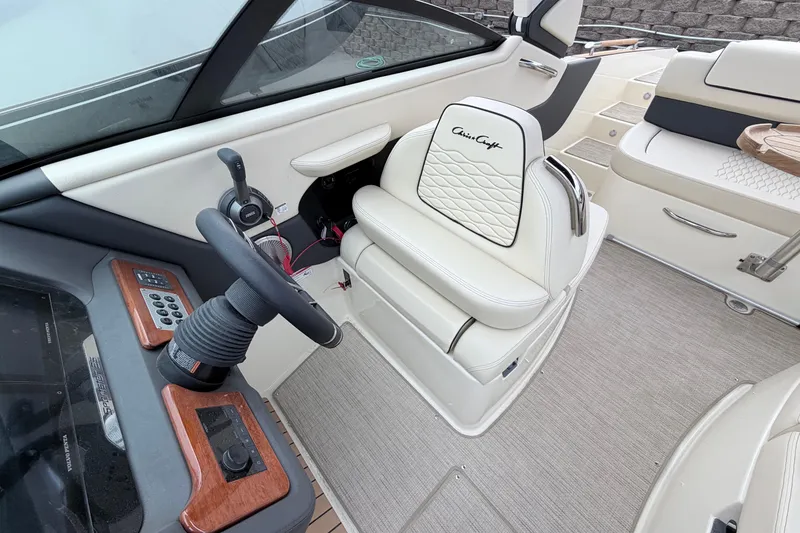 Slide: The Image of 2026 Chris-Craft Sportster 25 interior with elegant white seating and modern dashboard controls. - 25