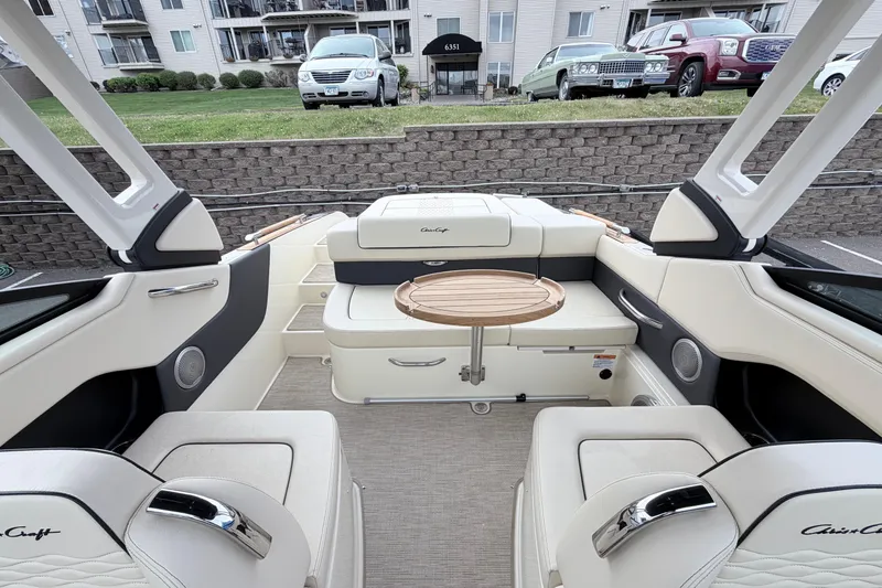 Slide: The Image of Luxurious interior of 2026 Chris-Craft Sportster 25 boat with elegant seating and wooden table. - 26