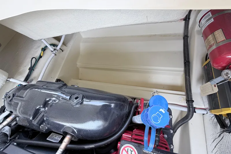 Slide: The Image of Engine compartment of 2026 Chris-Craft Sportster 25 with visible components and fire extinguisher. - 30