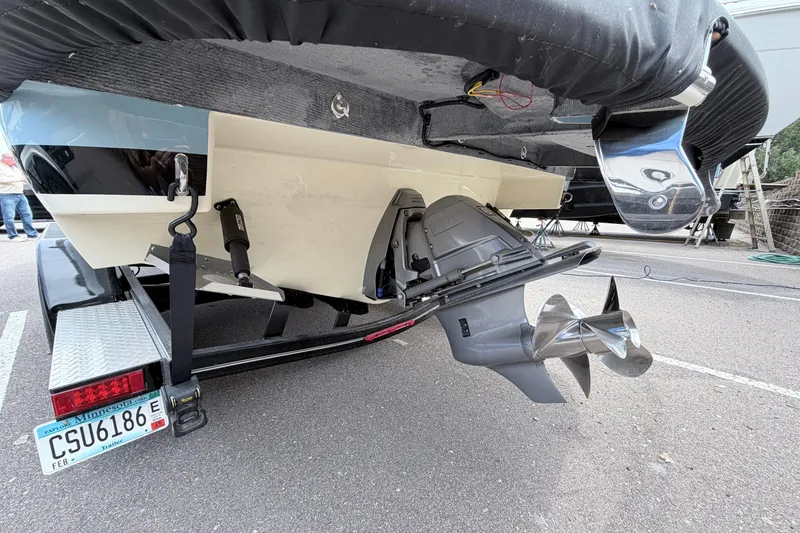 Slide: The Image of 2026 Chris-Craft Sportster 25 boat on trailer, showcasing propeller and rear design. - 31