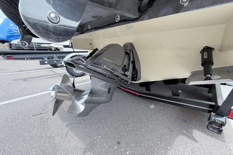 Slide: The Image of 2026 Chris-Craft Sportster 25 boat propeller and stern view in a parking lot. - 32