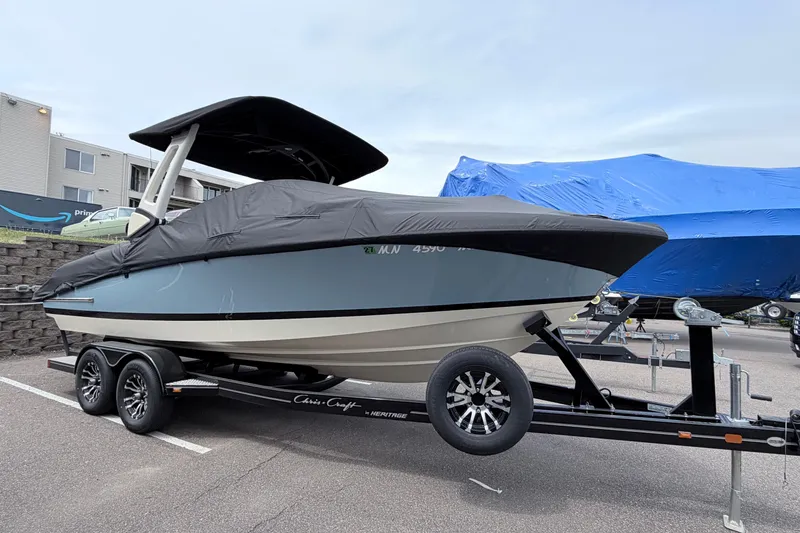 Slide: The Image of 2026 Chris-Craft Sportster 25 boat on trailer, covered and parked outdoors. - 37