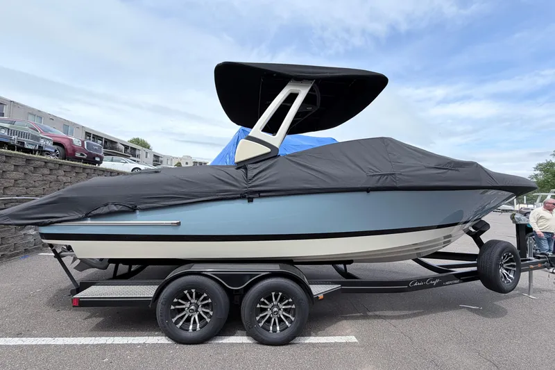 Slide: The Image of 2026 Chris-Craft Sportster 25 boat on trailer, covered, parked outdoors. - 38