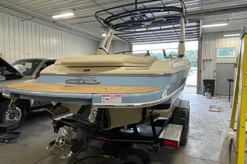 Slide: The Image of 2026 Chris-Craft Sportster 25 boat in a garage, showcasing sleek design and modern features. - 4