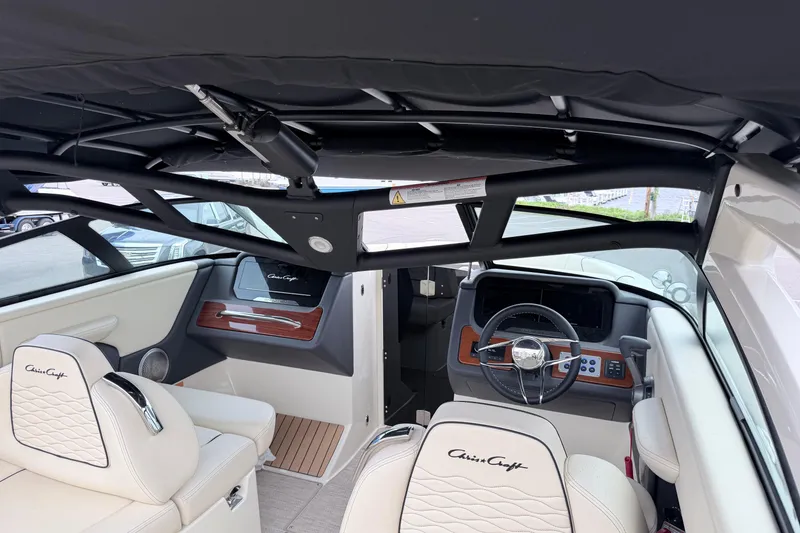 Slide: The Image of Interior of 2026 Chris-Craft Sportster 25 boat, featuring luxurious seating and modern dashboard. - 42