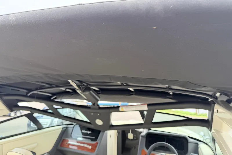 Slide: The Image of 2026 Chris-Craft Sportster 25 interior view with black canopy and dashboard details. - 43