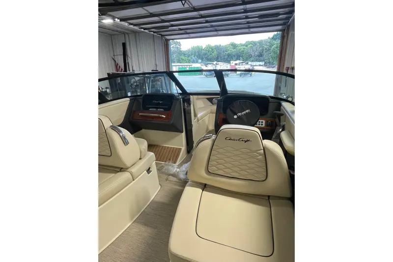 Slide: The Image of Interior of 2026 Chris-Craft Sportster 25 boat with luxurious seating and dashboard. - 5