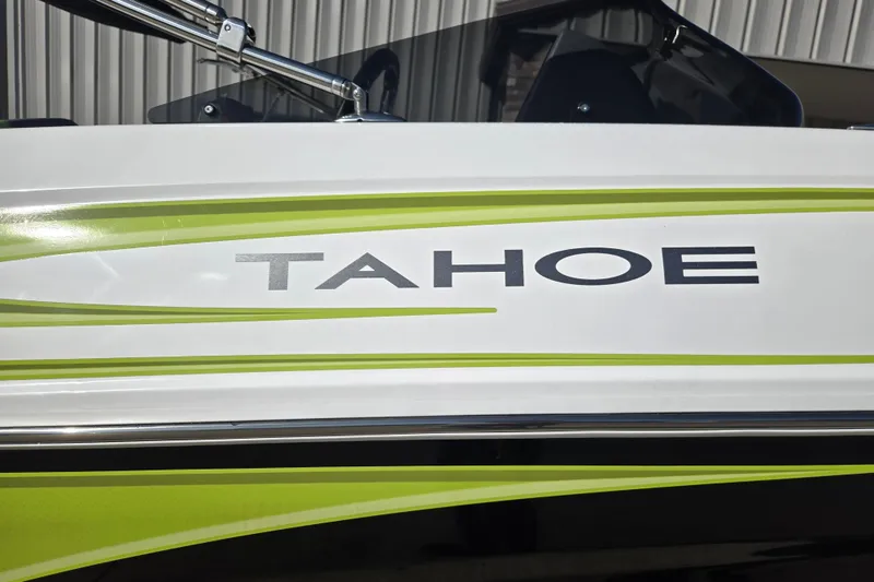 Slide: The Image of 2023 Tahoe T18 boat with green and white design accents. - 11