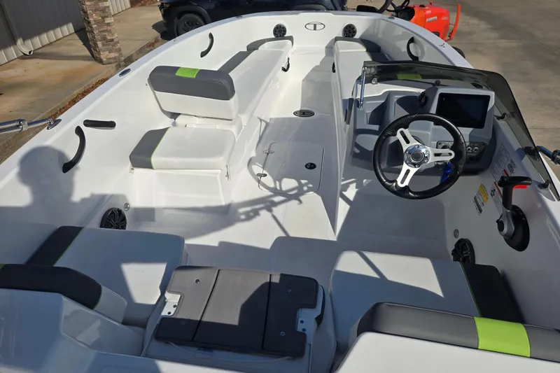 Slide: The Image of 2023 Tahoe T18 boat interior with modern seating and steering console. - 14