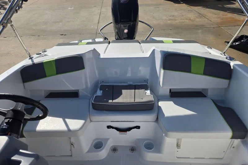 Slide: The Image of 2023 Tahoe T18 boat interior with seating and steering wheel, featuring green accents. - 20