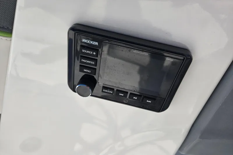 Slide: The Image of Kicker media center in 2023 Tahoe T18 boat, featuring control buttons and display. - 21