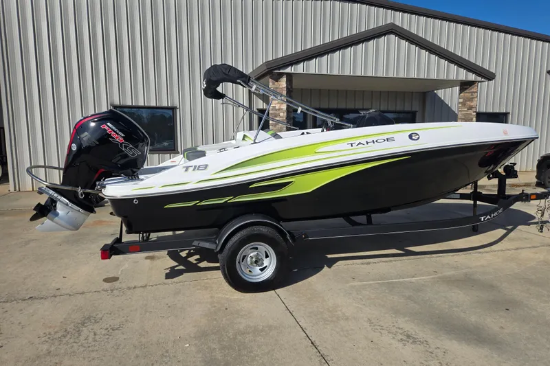 Slide: The Image of 2023 Tahoe T18 boat with trailer, parked outside a building. - 5