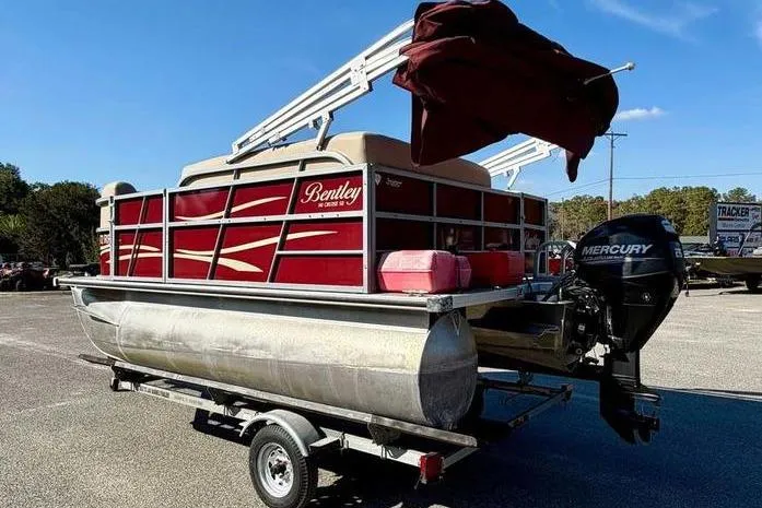 Slide: The Image of 2017 Bentley Pontoons 140 Cruise on trailer with Mercury outboard motor, red and beige design. - 7