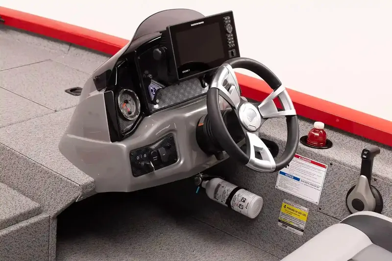 Slide: The Image of 2026 G3 Sportsman 1810 PFX boat interior with gray seating and storage compartments. - 5