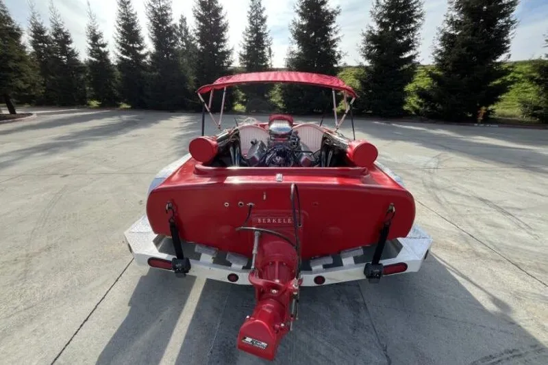 Slide: The Image of Red 1975 Weirdt Maverick boat with Berkeley jet drive, parked outdoors. - 15