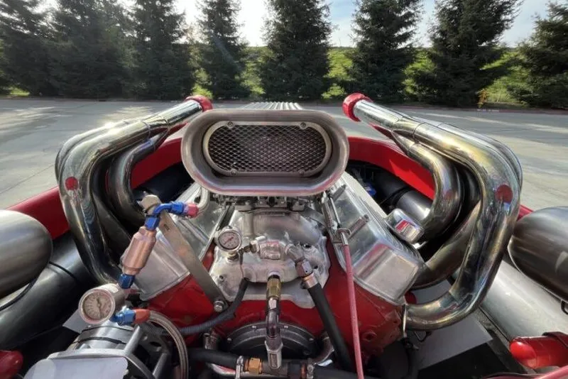 Slide: The Image of 1975 Weirdt Maverick engine with chrome pipes and air intake, outdoors. - 17