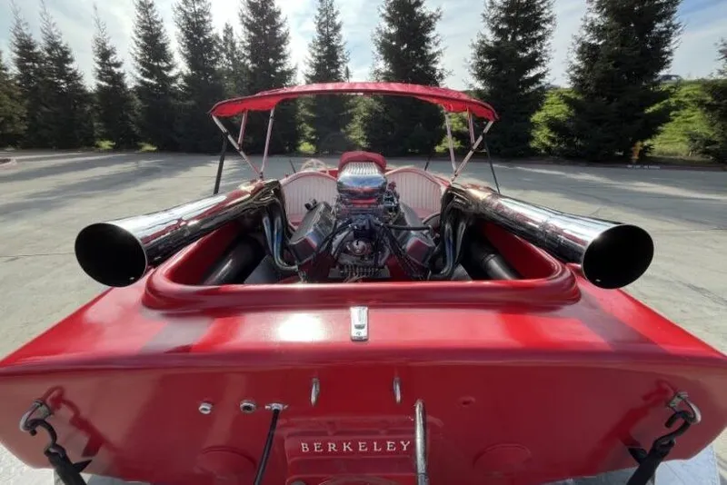 Slide: The Image of Red 1975 Weirdt Maverick boat with powerful engine and dual exhausts, parked outdoors. - 18