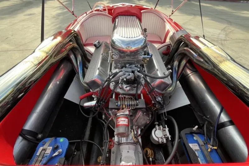 Slide: The Image of 1975 Weirdt Maverick engine in a red speedboat, showcasing powerful mechanics and sleek design. - 19