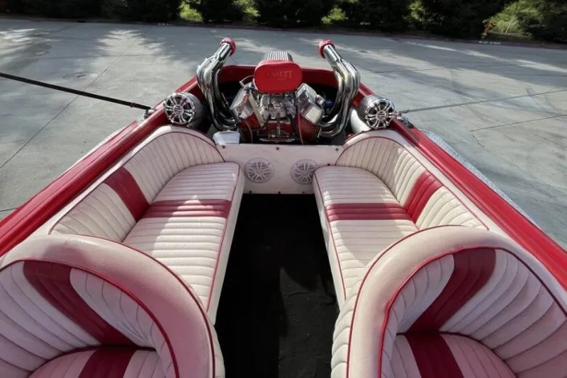 Slide: The Image of 1975 Weirdt Maverick interior with red and white seating, exposed engine, and chrome details. - 21