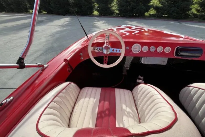 Slide: The Image of Interior of a 1975 Weirdt Maverick with red and white vintage design. - 23