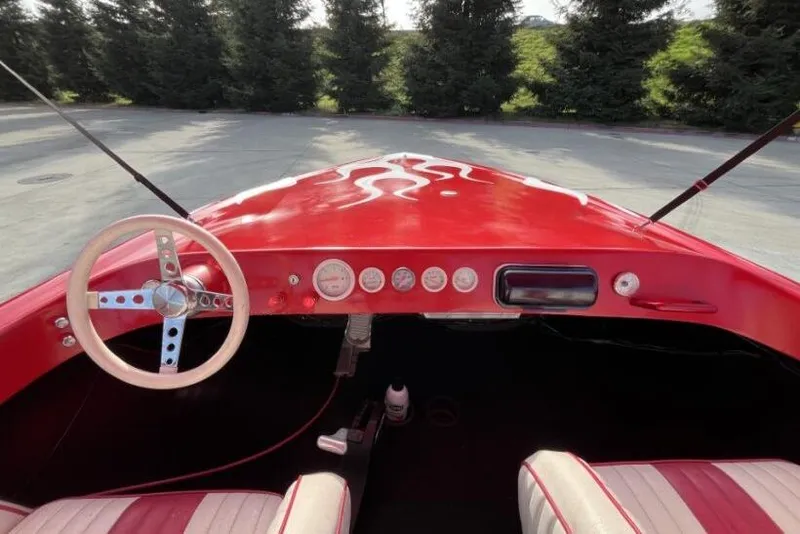 Slide: The Image of Red 1975 Weirdt Maverick dashboard with flame design, classic steering wheel, and vintage gauges. - 25