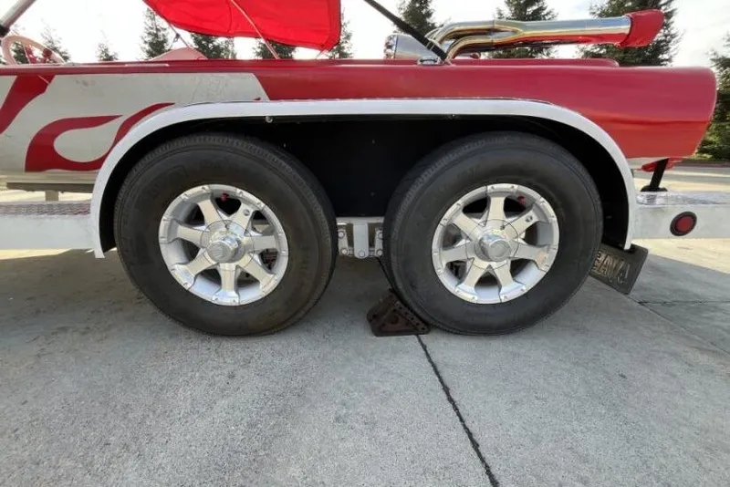 Slide: The Image of 1975 Weirdt Maverick trailer with dual wheels and red flame design. - 28