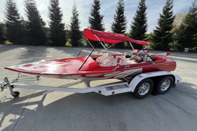 Slide: The Image of Red 1975 Weirdt Maverick speedboat on trailer with flame design and canopy. - 4