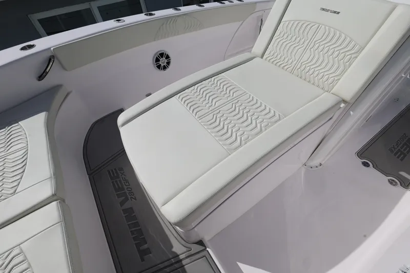 Slide: The Image of 2025 Twin Vee 280 GFX2 CC boat interior with white cushioned seating and sleek design. - 11