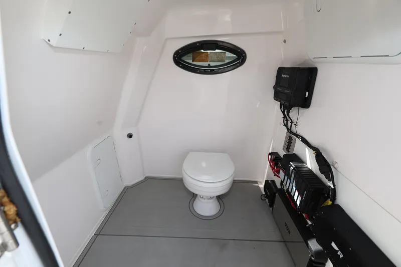 Slide: The Image of Interior of 2025 Twin Vee 280 GFX2 CC boat with toilet and electronic equipment. - 15