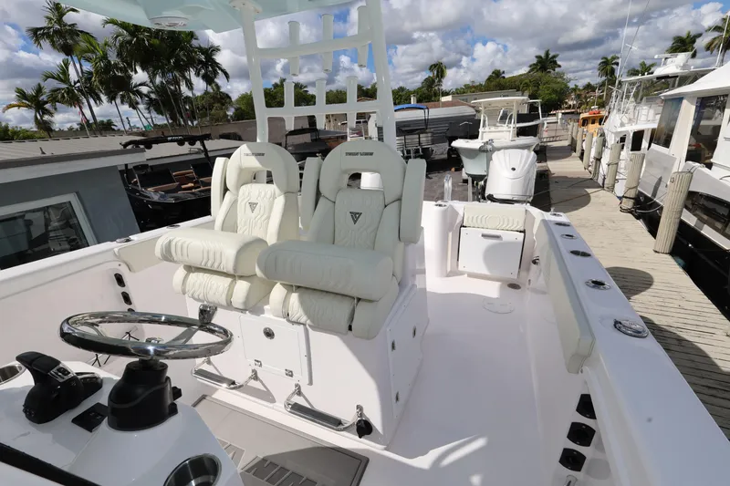 Slide: The Image of 2025 Twin Vee 280 GFX2 CC boat interior with plush seating and steering wheel. - 17