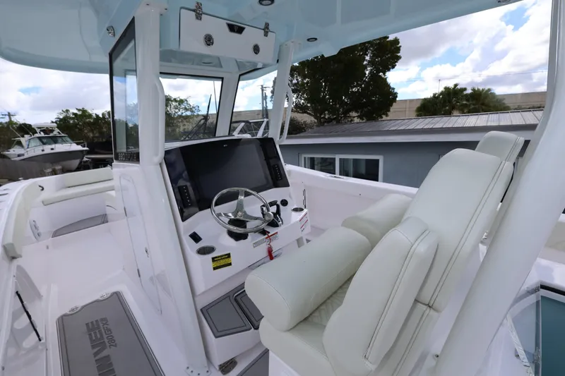 Slide: The Image of 2025 Twin Vee 280 GFX2 CC boat cockpit with modern steering and seating. - 22