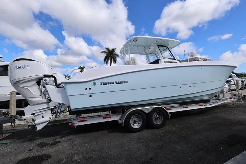 Slide: The Image of 2025 Twin Vee 280 GFX2 CC boat on trailer, featuring Yamaha outboard engines. - 3