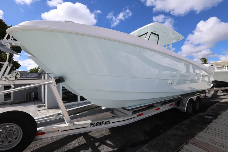 Slide: The Image of 2025 Twin Vee 280 GFX2 CC boat on trailer under blue sky. - 7