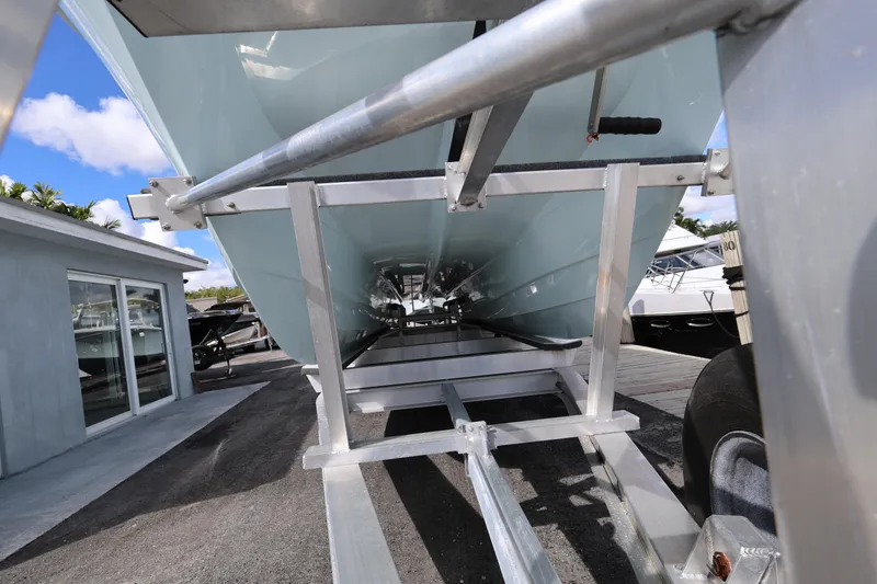 Slide: The Image of 2025 Twin Vee 280 GFX2 CC boat on trailer, viewed from below, showcasing hull design. - 8