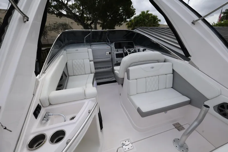 Slide: The Image of 2021 Regal 28 Express boat interior with white seating and steering area. - 12