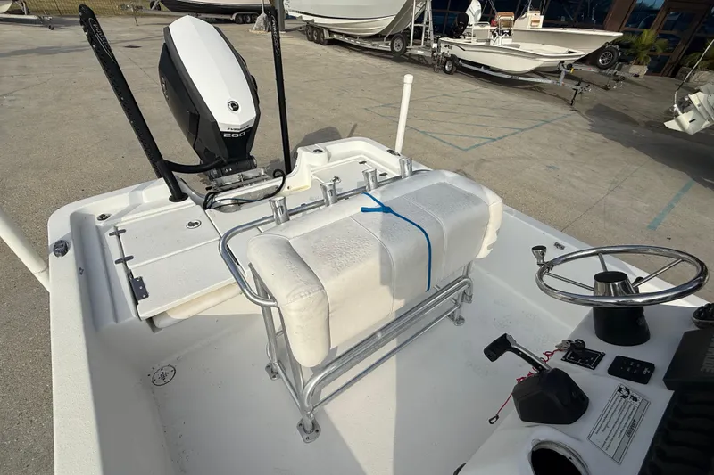 Slide: The Image of 2017 Blazer Bay 2200 boat interior with steering wheel and engine controls. - 13
